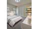 Cozy bedroom featuring a plush gray carpet, a neutral color scheme, and ample natural light at 4460 Branchwood Ct, Loganville, GA 30052