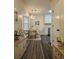 Elegant dining area with chandelier, hardwood floors, and access to kitchen at 4460 Branchwood Ct, Loganville, GA 30052