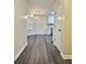 Hallway showcasing wood-look flooring, natural light from a window, and access to living spaces at 4460 Branchwood Ct, Loganville, GA 30052