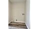 Convenient laundry room featuring wood-look flooring and utility hookups for washer and dryer at 4460 Branchwood Ct, Loganville, GA 30052
