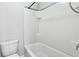 Clean bathroom featuring a white tiled shower and toilet at 4528 Venus Sw Ct, Powder Springs, GA 30127