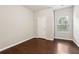 Neutral bedroom boasts hardwood floors, a window for natural light, and a closet at 4528 Venus Sw Ct, Powder Springs, GA 30127