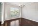 Bright dining area with hardwood floors, chandelier and a large window overlooking the neighborhood at 4528 Venus Sw Ct, Powder Springs, GA 30127