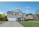 Traditional two-story home boasts a long driveway and a lush green lawn on a sunny day at 4528 Venus Sw Ct, Powder Springs, GA 30127