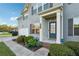 Inviting front entrance with a well-kept garden, gray siding, and a modern blue door at 4528 Venus Sw Ct, Powder Springs, GA 30127