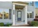 Detailed view of the front entrance showing a blue door and white columns supporting the porch at 4528 Venus Sw Ct, Powder Springs, GA 30127