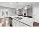 Kitchen island with granite countertops that overlooks the living area at 4528 Venus Sw Ct, Powder Springs, GA 30127