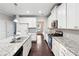 Well-appointed kitchen with granite countertops, stainless steel appliances, and white cabinets at 4528 Venus Sw Ct, Powder Springs, GA 30127