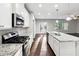 Modern kitchen with granite countertops, stainless appliances, and backyard views at 4528 Venus Sw Ct, Powder Springs, GA 30127