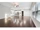 Open-concept living area with hardwood floors adjoining a modern, white kitchen at 4528 Venus Sw Ct, Powder Springs, GA 30127
