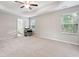 Large main bedroom featuring plush carpeting, a ceiling fan, two windows, and an attached bathroom at 4528 Venus Sw Ct, Powder Springs, GA 30127