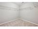 Carpeted walk-in closet features wire shelving on multiple walls at 4528 Venus Sw Ct, Powder Springs, GA 30127