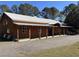 Large home with a long porch and expansive gravel driveway at 639 Hall Station Rd, Kingston, GA 30145