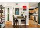 Cozy dining room area with hardwood floors, stylish wall art, and a view into the adjacent kitchen space at 1355 Euclid Ne Ave # 15A, Atlanta, GA 30307