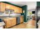 Well-lit kitchen with stainless steel appliances, granite countertops, light brown cabinetry, and a subway tile backsplash at 1355 Euclid Ne Ave # 15A, Atlanta, GA 30307