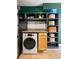 A kitchenette features a stacked washer/dryer combo, shelving, granite countertops, and a stainless steel refrigerator at 1355 Euclid Ne Ave # 15A, Atlanta, GA 30307
