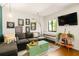 Bright living room with hardwood floors, comfortable seating, stylish decor, and a large window for natural light at 1355 Euclid Ne Ave # 15A, Atlanta, GA 30307