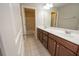 Bathroom featuring a double sink vanity, tile floor, large mirror and separate water closet at 2034 W Hampton Dr, Canton, GA 30115