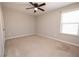 Bedroom featuring a ceiling fan, neutral walls and carpet, and a bright window at 2034 W Hampton Dr, Canton, GA 30115