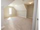 Bright bonus room featuring neutral walls, carpet, and ample closet space with attic access; great for storage or customization at 2034 W Hampton Dr, Canton, GA 30115