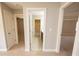 Hallway showcasing multiple doorways and a tile floor bathroom at 2034 W Hampton Dr, Canton, GA 30115