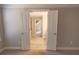 Bright hallway featuring double doors, leading to an ensuite bathroom and views of an upper-level space at 2034 W Hampton Dr, Canton, GA 30115