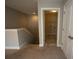 Hallway view to the laundry room on the second floor of the home with carpet flooring at 2034 W Hampton Dr, Canton, GA 30115
