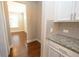 Kitchen area featuring granite countertops, white cabinets, and a gray tile backsplash at 2034 W Hampton Dr, Canton, GA 30115