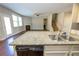 Open kitchen with granite countertops and stainless steel sink overlooks the living room and a fireplace at 2034 W Hampton Dr, Canton, GA 30115
