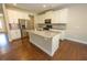Kitchen features granite countertops, stainless steel appliances, and white cabinets with hardwood floors at 2034 W Hampton Dr, Canton, GA 30115