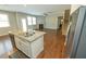 Open kitchen with granite countertops and island overlooks living room with fireplace and hardwood floors at 2034 W Hampton Dr, Canton, GA 30115