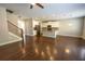 Wide view of open-concept living area with hardwood floors, kitchen, and staircase at 2034 W Hampton Dr, Canton, GA 30115