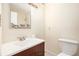 Bathroom with vanity, framed mirror, sink, lighting, toilet, and shower with tile surround at 233 Cobblestone Trl, Avondale Estates, GA 30002