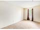 This bedroom features neutral carpet, a window with blinds, and curtain accents at 233 Cobblestone Trl, Avondale Estates, GA 30002