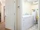 Laundry area features a washing machine, dryer, water heater, and tile flooring at 233 Cobblestone Trl, Avondale Estates, GA 30002