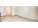 Living room space featuring neutral carpet, base trim, and adjacent hall and closet space at 233 Cobblestone Trl, Avondale Estates, GA 30002