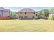 Large, grassy backyard with a privacy fence and a patio area, providing ample space for recreation at 2424 Malden Park Dr, Buford, GA 30519