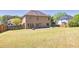 Expansive backyard featuring a well-kept lawn, fire pit area, and privacy fence, ideal for entertaining at 2424 Malden Park Dr, Buford, GA 30519