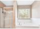 Bathroom with a shower and a bath beneath a window with blinds at 2424 Malden Park Dr, Buford, GA 30519