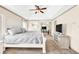 Bedroom with white tray ceiling, ceiling fan, and a tv stand at 2424 Malden Park Dr, Buford, GA 30519