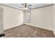 Cozy bedroom featuring neutral walls, carpeted flooring, and a ceiling fan with natural light at 2424 Malden Park Dr, Buford, GA 30519