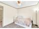 Bright bedroom featuring neutral walls, carpeted flooring, and a ceiling fan for comfortable living at 2424 Malden Park Dr, Buford, GA 30519