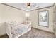 Charming bedroom with neutral walls, carpeted flooring, and a ceiling fan providing ample light at 2424 Malden Park Dr, Buford, GA 30519