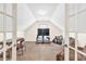 Bright bonus room with a TV, a desk, and comfortable seating at 2424 Malden Park Dr, Buford, GA 30519