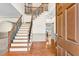 Spacious foyer featuring hardwood floors, elegant staircase, and neutral paint at 2424 Malden Park Dr, Buford, GA 30519