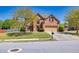Beautiful two-story brick home with a well-manicured lawn, mature trees, and a welcoming entrance at 2424 Malden Park Dr, Buford, GA 30519