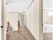A carpeted hallway featuring neutral walls, white trim and multiple doorways leading to bedrooms at 2424 Malden Park Dr, Buford, GA 30519