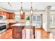 The well-lit kitchen features a large granite island, stainless steel appliances, and hardwood floors at 2424 Malden Park Dr, Buford, GA 30519