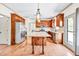 Well-lit kitchen features a granite island, stainless steel appliances, and hardwood floors at 2424 Malden Park Dr, Buford, GA 30519
