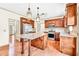 The well-lit kitchen features a large granite island, stainless steel appliances, and hardwood floors at 2424 Malden Park Dr, Buford, GA 30519